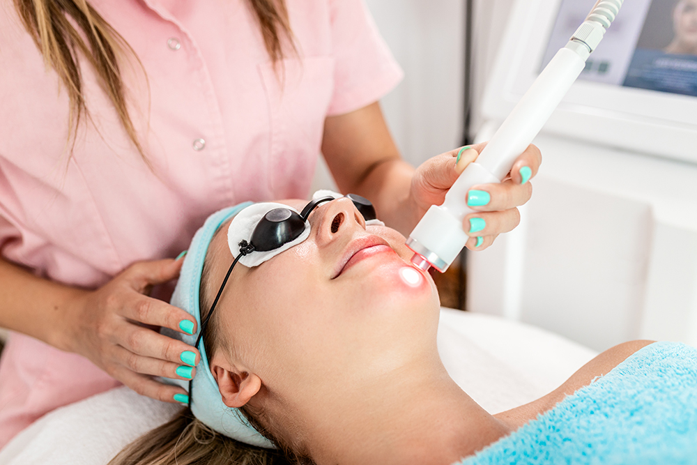 A woman undergoing a laser facial treatment